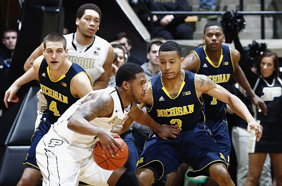 Mitch McGary (4), Trey Burke (3), and Glenn Robinson III (1)