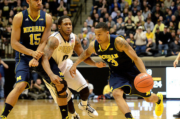 Jon Horford (15) and Trey Burke (3)