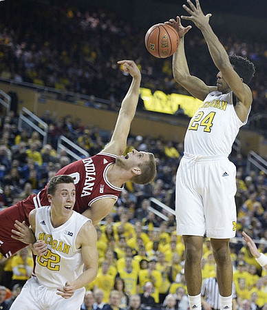 Duncan Robinson (22), Former Michigan Player Max Bielfeldt, and Aubrey Dawkins (24)