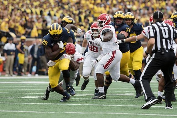 Hassan Haskins (25), Ben Bredeson (74), and Jalen Mayfield (73)