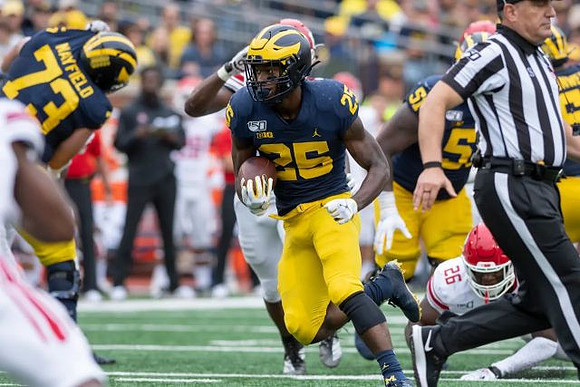 Jalen Mayfield (73), Hassan Haskins (25), and Cesar Ruiz (51)