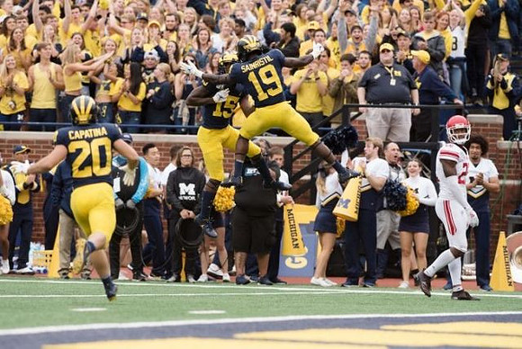 Nicholas Capatina (20), Giles Jackson (15), and Mike Sainristil (19)