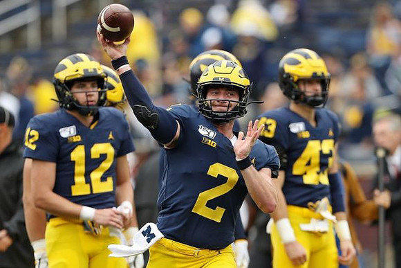 Cade McNamara (12), Shea Patterson (2), and Jake McCurry (43)