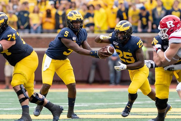 Ben Bredeson (74), Joe Milton (5), Hassan Haskins (25), and Jon Runyan Jr. (75)