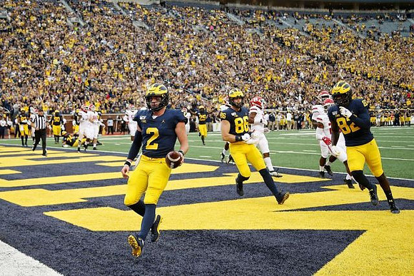 Shea Patterson (2), Hassan Haskins (25), Luke Schoonmaker (86), and Nick Eubanks (82)