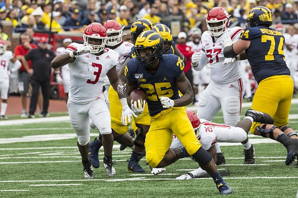 Hassan Haskins (25) and Ben Bredeson (74)