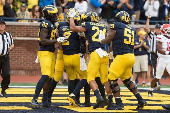Nick Eubanks (82), Shea Patterson (2), Zach Charbonnet (24), and Cesar Ruiz (51)