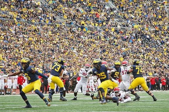 Cornelius Johnson (6), Jalen Mayfield (73), Hassan Haskins (25), Cesar Ruiz (51), and Ben Bredeson (74)