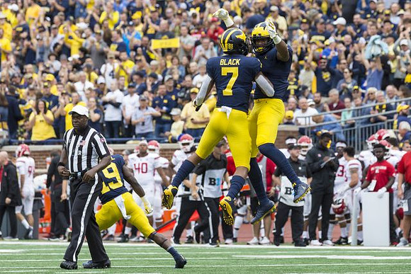 Mike Sainristil (19), Tarik Black (7), and Nico Collins (4)