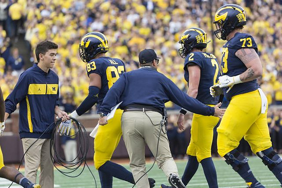 Erick All (83), Jim Harbaugh, Shea Patterson (2), and Jalen Mayfield (73)