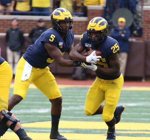 Joe Milton (5) and Hassan Haskins (25)