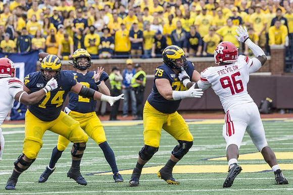 Ben Bredeson (74), Shea Patterson (2), and Jon Runyan Jr. (75)