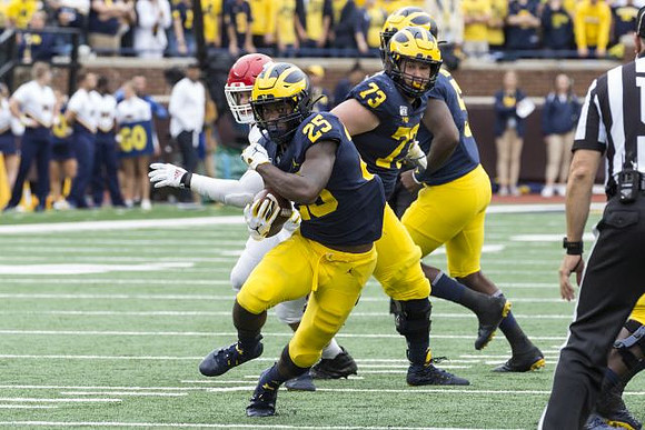 Hassan Haskins (25), Jalen Mayfield (73), and Joe Milton (5)