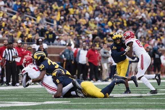 Daxton Hill (30), Devin Gil (8), and Jaylen Kelly-Powell (16)