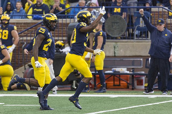 Hassan Haskins (25) and Daxton Hill (30)