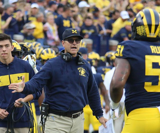 Jim Harbaugh and Cesar Ruiz (51)