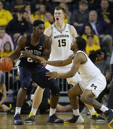 Jon Teske (15) and Zavier Simpson (3)