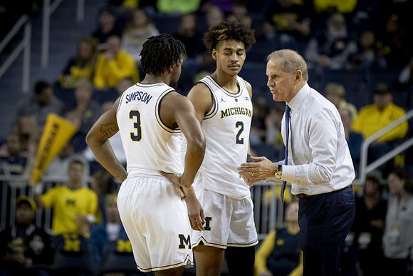 Zavier Simpson (3), Jordan Poole (2), and John Beilein