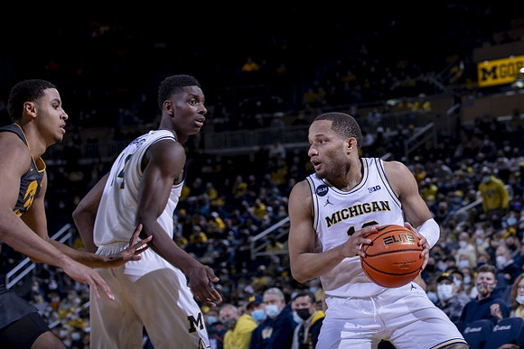 Moussa Diabate (14) and DeVante' Jones (12)