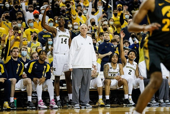 Moussa Diabate (14), Phil Martelli, and Michigan Team
