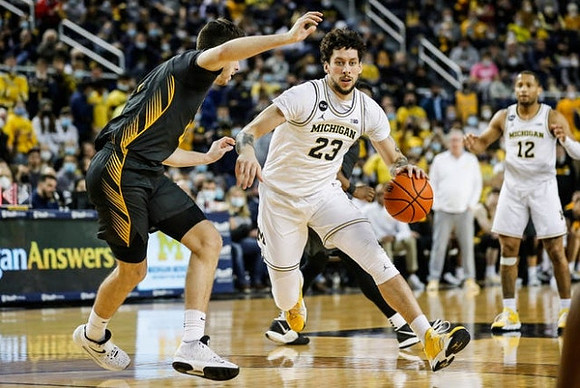 Brandon Johns Jr. (23) and DeVante' Jones (12)