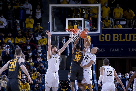 Hunter Dickinson (1), Caleb Houstan (22), and DeVante' Jones (12)