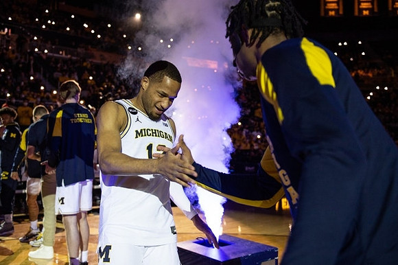 DeVante' Jones (12) and Michigan Team
