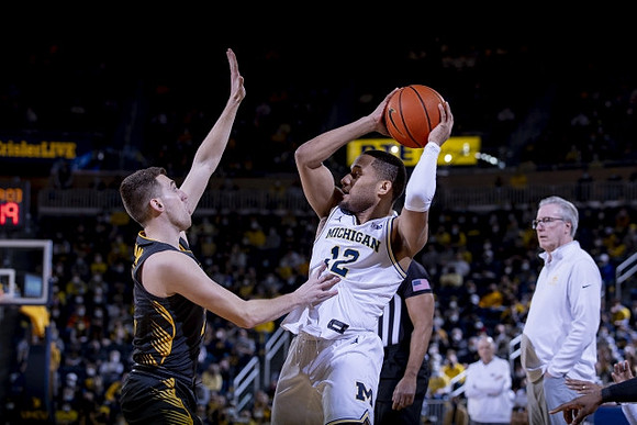 DeVante' Jones (12) and Iowa Head Coach Fran McCaffery