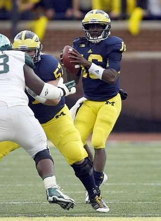Elliott Mealer (57) and Denard Robinson (16)