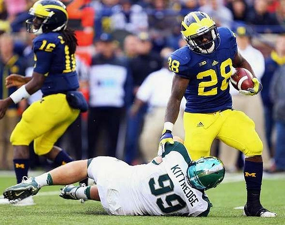 Denard Robinson (16) and Fitzgerald Toussaint (28)