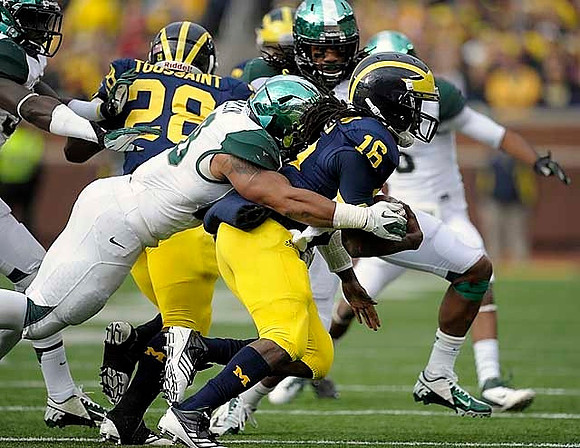 Denard Robinson (16) and Fitzgerald Toussaint (28)