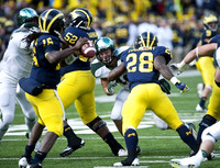 Denard Robinson (16), Ricky Barnum (52), and Fitzgerald Toussaint (28)
