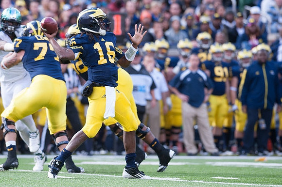 Taylor Lewan (77), Ricky Barnum (52),  and Denard Robinson (16)