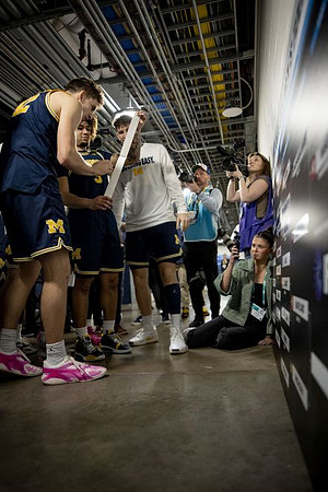 Will Tschetter (42), Tre Donaldson (3), and Michigan Team