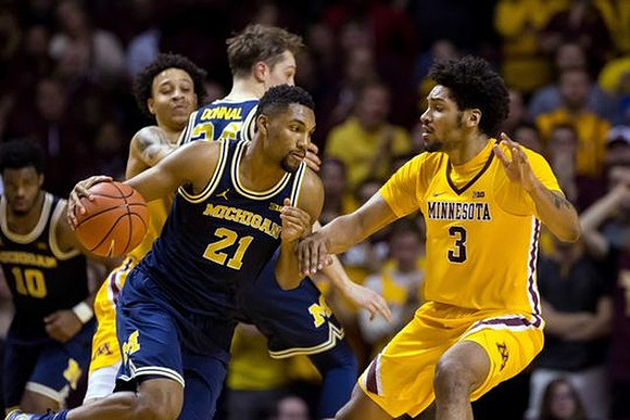 Derrick Walton Jr. (10), Mark Donnal (34), and Zak Irvin (21)