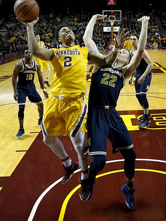 Derrick Walton Jr. (10), Duncan Robinson (22), and Mark Donnal (34)