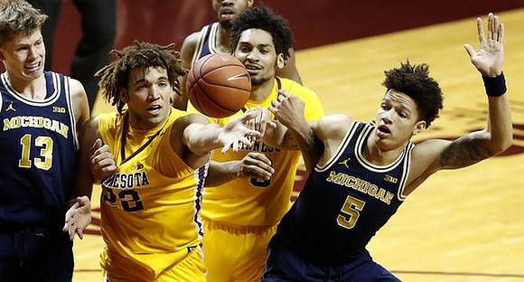 Moritz Wagner (13), Derrick Walton Jr. (10), and D.J. Wilson (5)