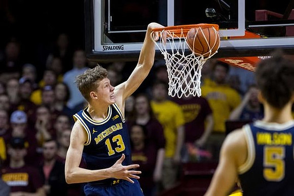 Moritz Wagner (13) and D.J. Wilson (5)
