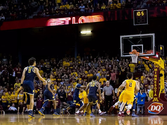 D.J. Wilson (5), Zak Irvin (21), Muhammad-Ali Abdur-Rahkman (12), and Derrick Walton Jr. (10)