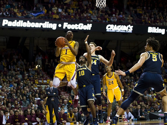 Derrick Walton Jr. (10), Mark Donnal (34), D.J. Wilson (5), and Minnesota Head Coach Richard Pitino