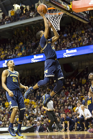 Zak Irvin (21), Muhammad-Ali Abdur-Rahkman (12), and Derrick Walton Jr. (10)