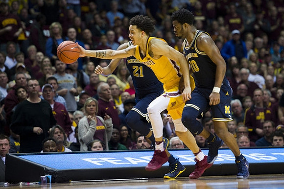 Zak Irvin (21) and Derrick Walton Jr. (10)