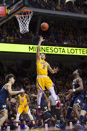 D.J. Wilson (5) and Derrick Walton Jr. (10)