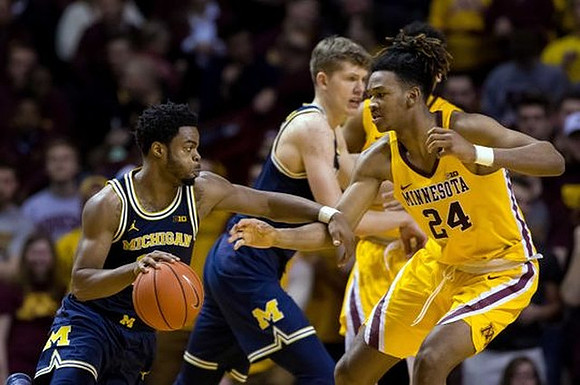 Derrick Walton Jr. (10) and Moritz Wagner (13)