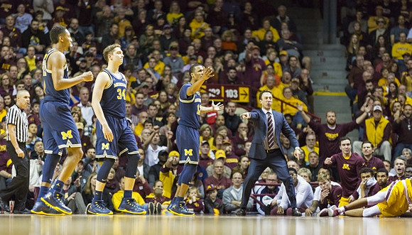 Zak Irvin (21), Mark Donnal (34), Muhammad-Ali Abdur-Rahkman (12), and Minnesota Head Coach Richard Pitino