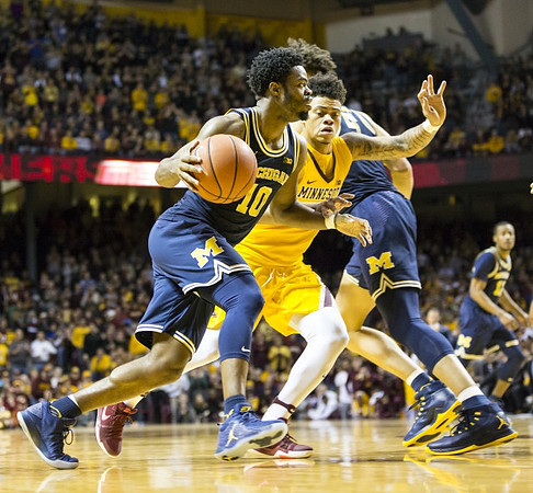 Derrick Walton Jr. (10), D.J. Wilson (5), and Muhammad-Ali Abdur-Rahkman (12)