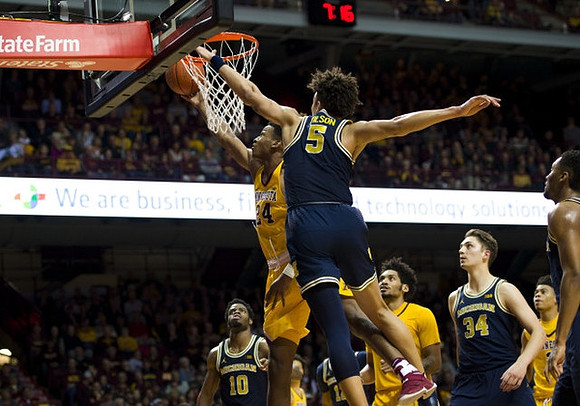 Derrick Walton Jr. (10), D.J. Wilson (5), Mark Donnal (34), and Zak Irvin (21)