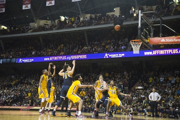 D.J. Wilson (5), Moritz Wagner (13), and John Beilein