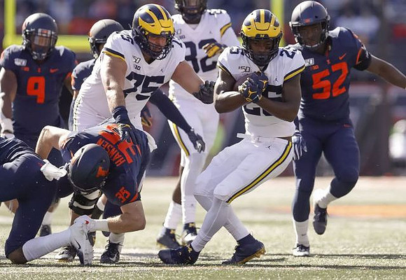 Jon Runyan Jr. (75), Nick Eubanks (82), and Hassan Haskins (25)