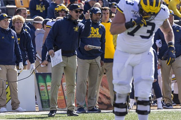 Jim Harbaugh and Jalen Mayfield (73)